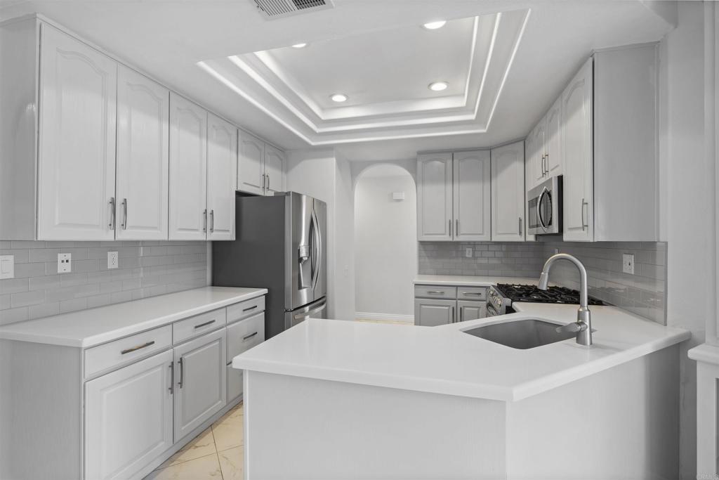 3355 Genoa Way, Unit 134 Oceanside, CA 92056 - Photo 21 of 45 a kitchen with refrigerator and cabinets