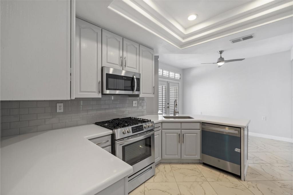 3355 Genoa Way, Unit 134 Oceanside, CA 92056 - Photo 22 of 45 a kitchen with a stove sink and microwave