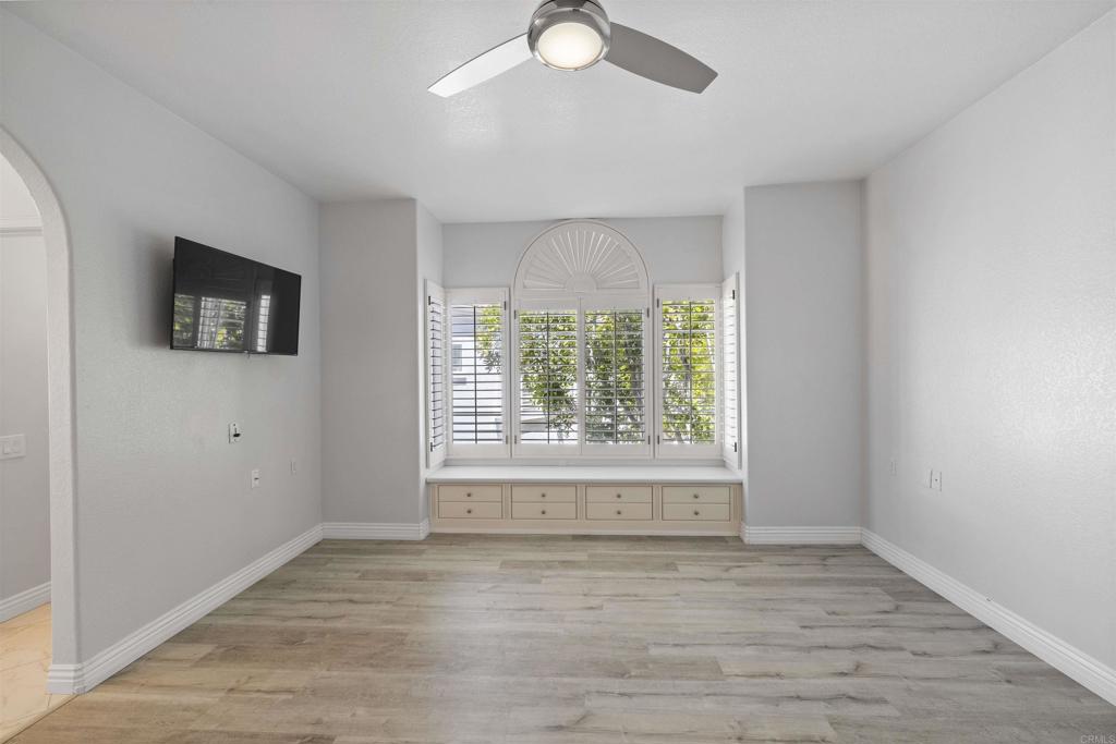 3355 Genoa Way, Unit 134 Oceanside, CA 92056 - Photo 32 of 45 an empty room with wooden floor and windows