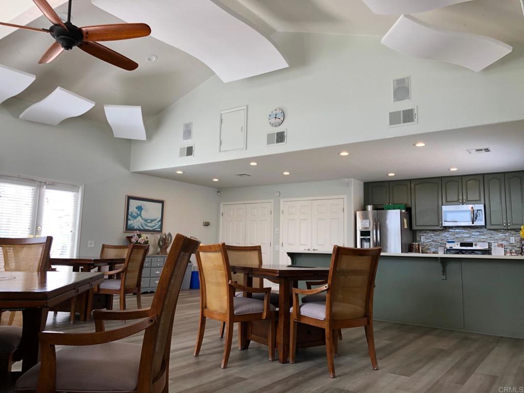 3355 Genoa Way, Unit 134 Oceanside, CA 92056 - Photo 43 of 45 a view of a dining area with furniture and wooden floor