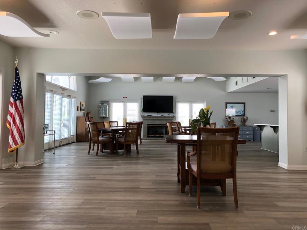 3355 Genoa Way, Unit 134 Oceanside, CA 92056 - Photo 44 of 45 a view of a dining room with furniture and wooden floor