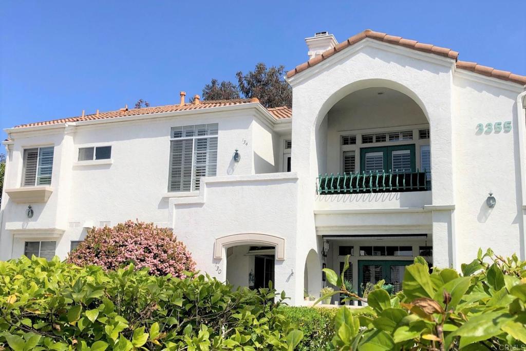 3355 Genoa Way, Unit 134 Oceanside, CA 92056 - Photo 5 of 45 a view of a house with large windows and a small yard