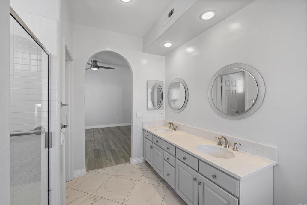 3355 Genoa Way, Unit 134 Oceanside, CA 92056 - Photo 6 of 45 a bathroom with a double vanity sink mirror and shower