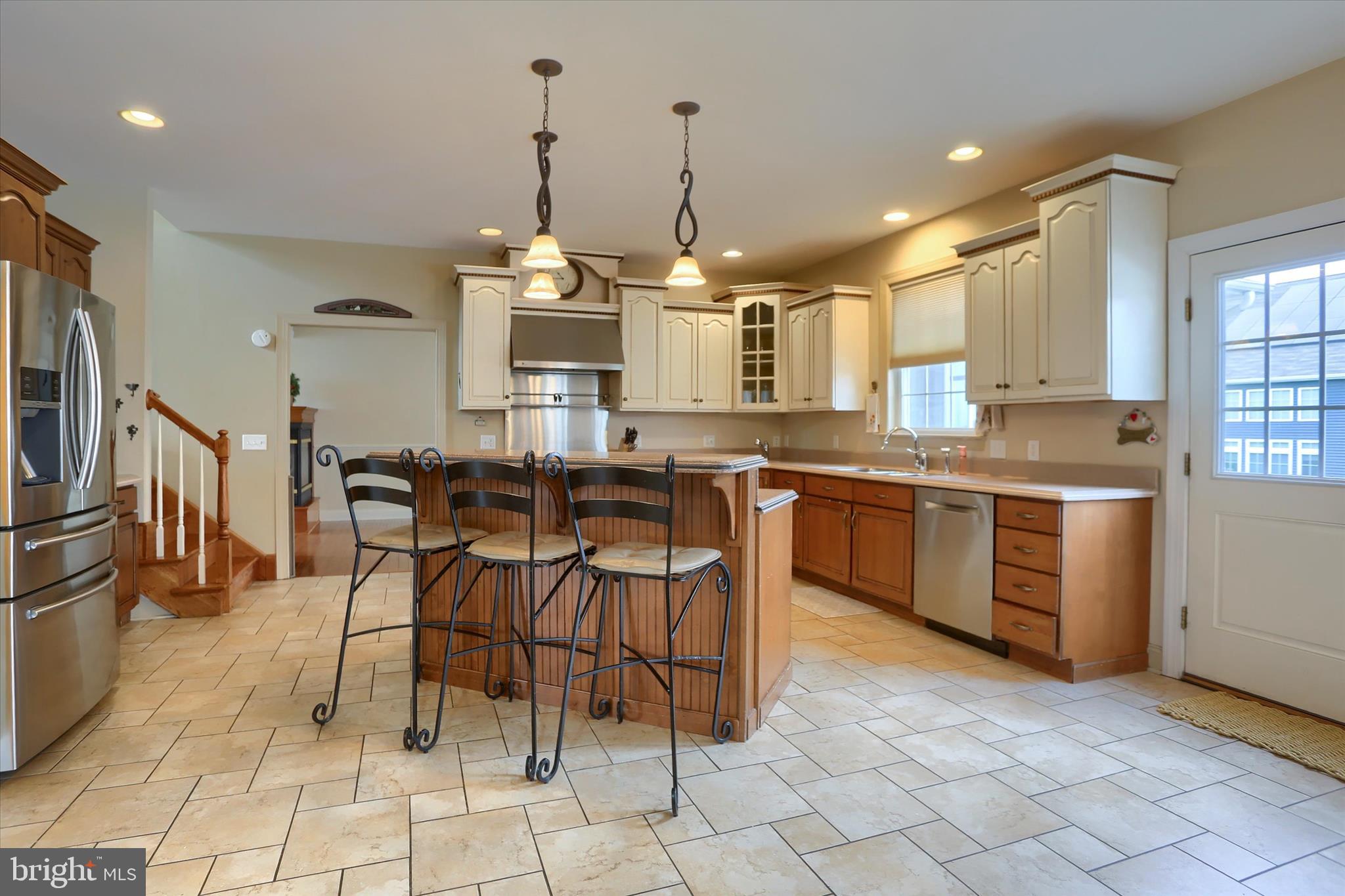 10 Spring View Court Mechanicsburg, PA 17050 - Photo 15 of 50 a kitchen with stainless steel appliances granite countertop a stove a sink a oven a dining table and chairs
