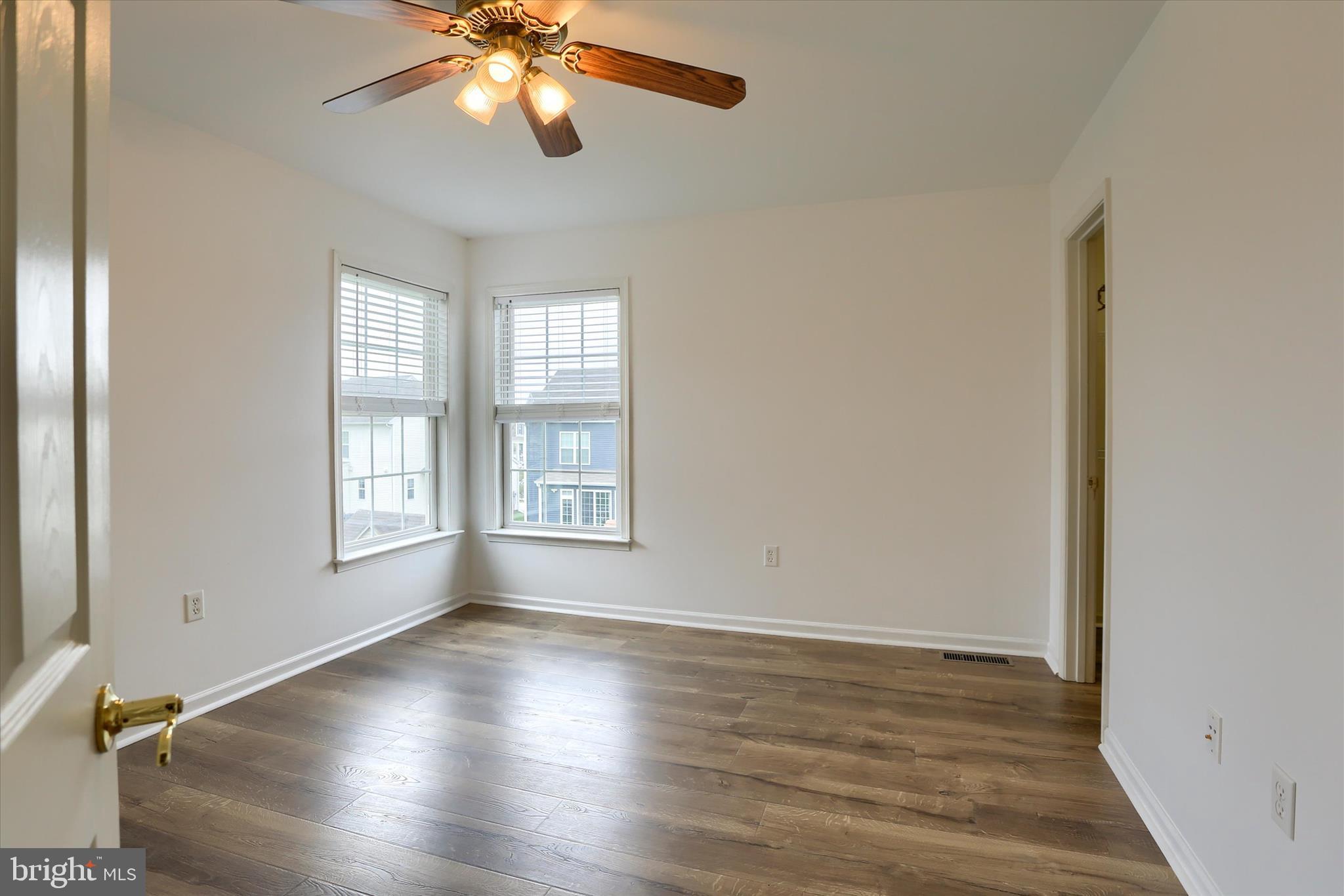 10 Spring View Court Mechanicsburg, PA 17050 - Photo 25 of 50 an empty room with wooden floor chandelier fan and windows