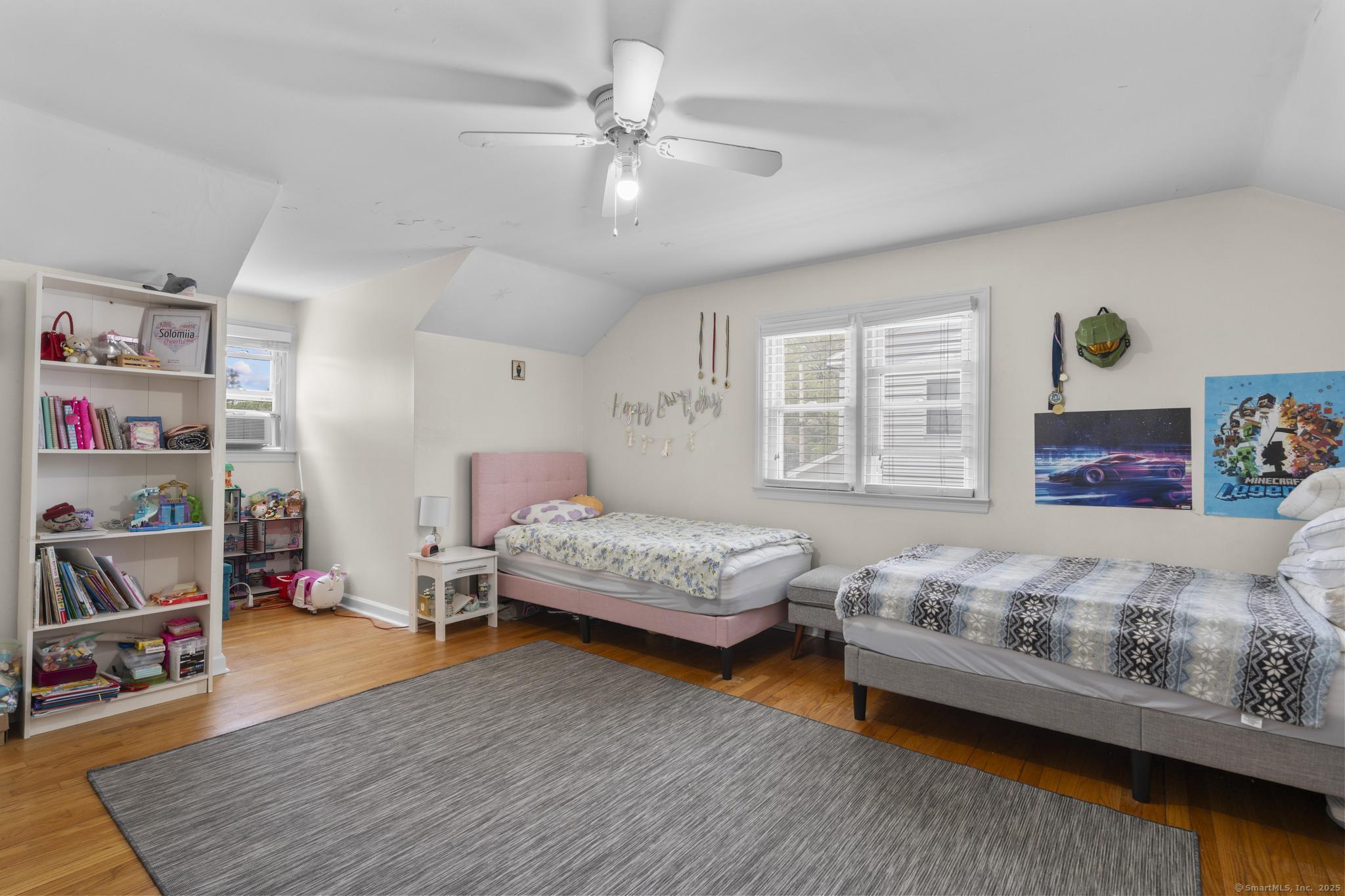 214 Country Road Fairfield, CT 06824 - Photo 15 of 20 a bedroom with a bed and a couch