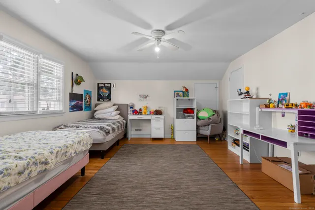 a bedroom with bed and window