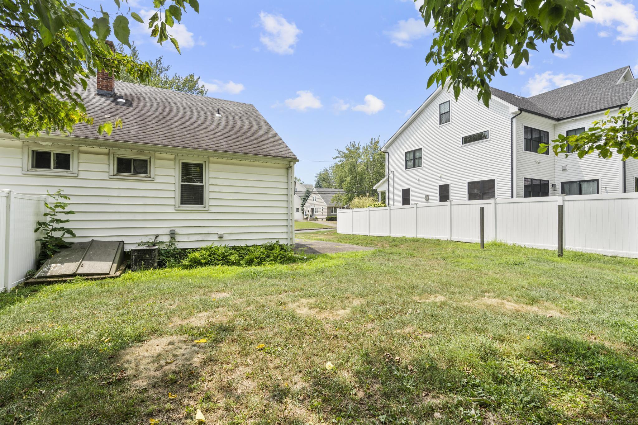 214 Country Road Fairfield, CT 06824 - Photo 18 of 20 a front view of a house with a yard and garage