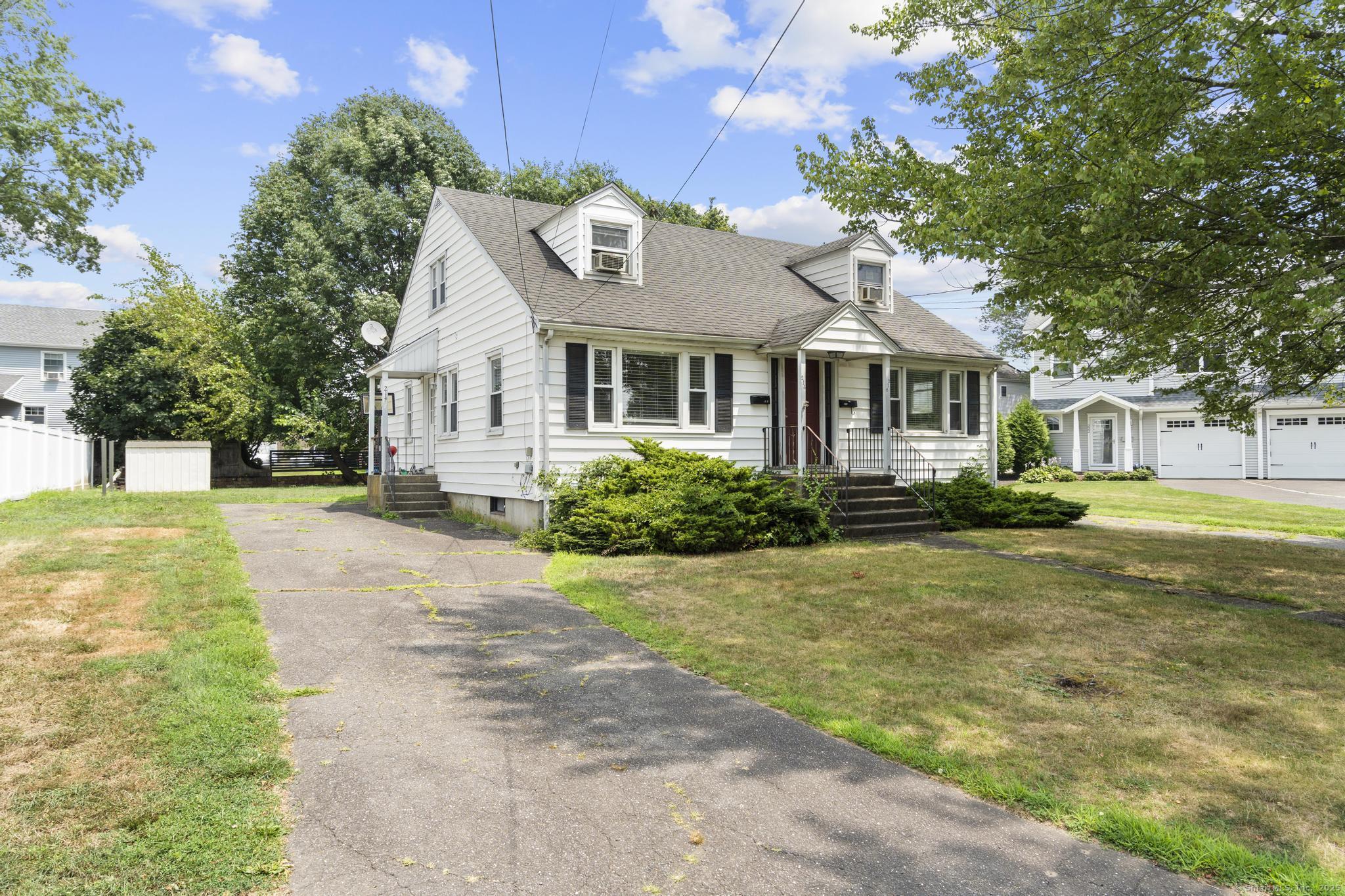214 Country Road Fairfield, CT 06824 - Photo 20 of 20 a front view of a house with a yard and trees