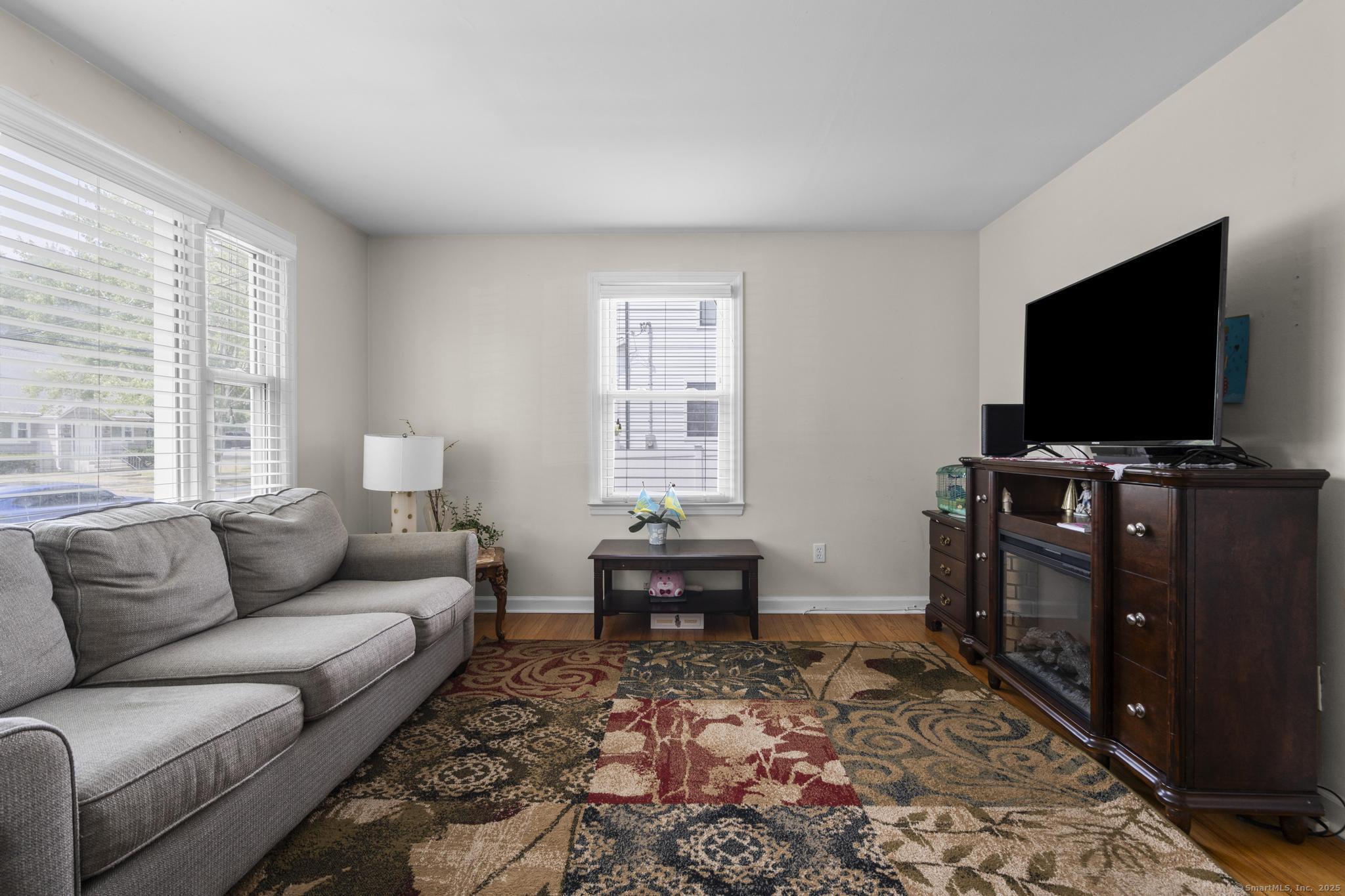 214 Country Road Fairfield, CT 06824 - Photo 3 of 20 a living room with furniture and a flat screen tv