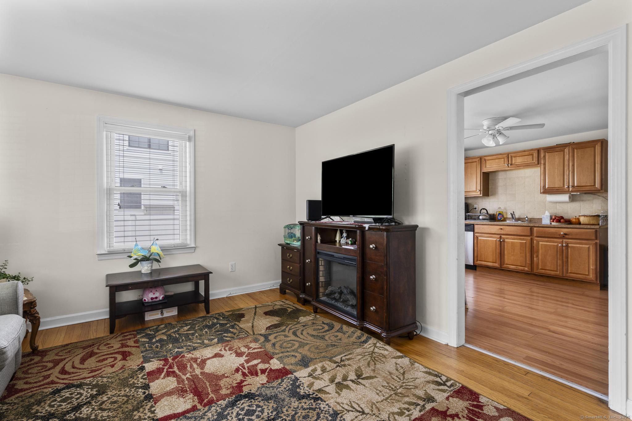 214 Country Road Fairfield, CT 06824 - Photo 5 of 20 a living room with furniture and a flat screen tv