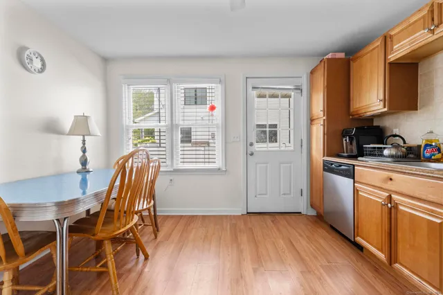 a view of a kitchen with furniture and wooden floor