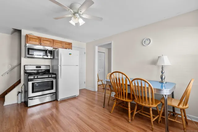 a dining room with furniture a chandelier and wooden floor