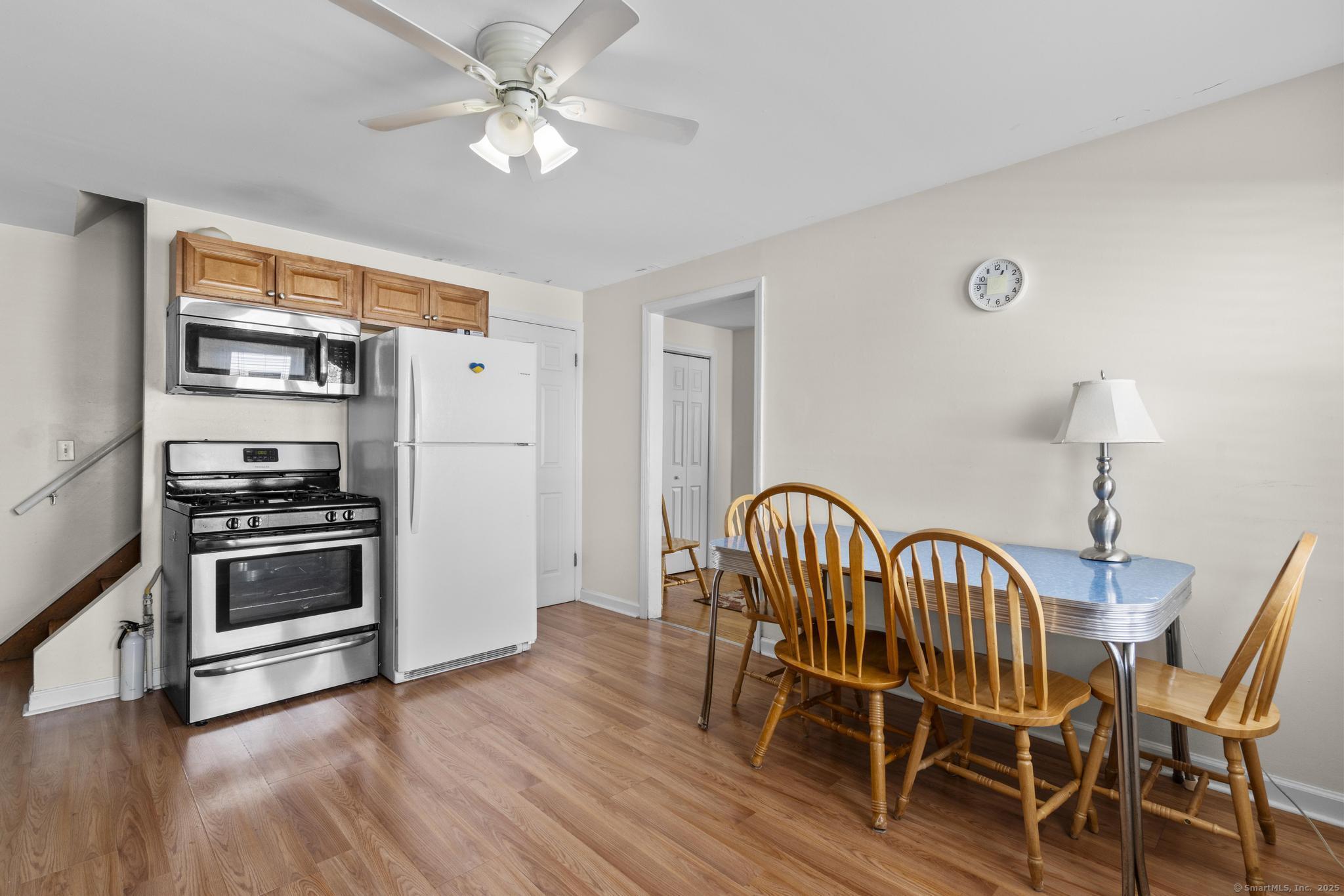 214 Country Road Fairfield, CT 06824 - Photo 7 of 20 a dining room with furniture a chandelier and wooden floor