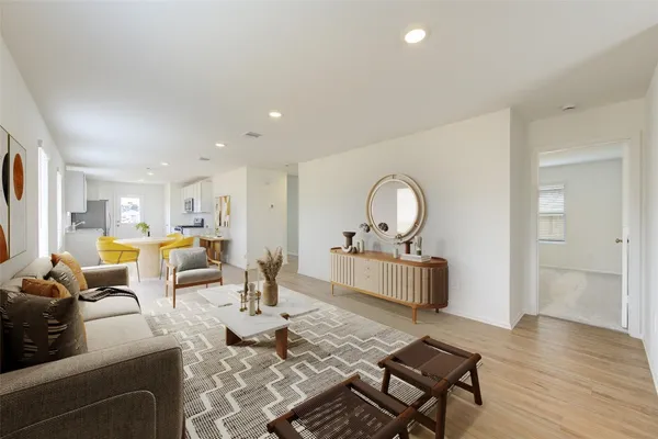 a living room with dining room and wooden floor