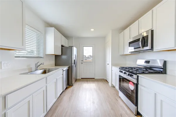 a kitchen with stainless steel appliances granite countertop a stove and a sink