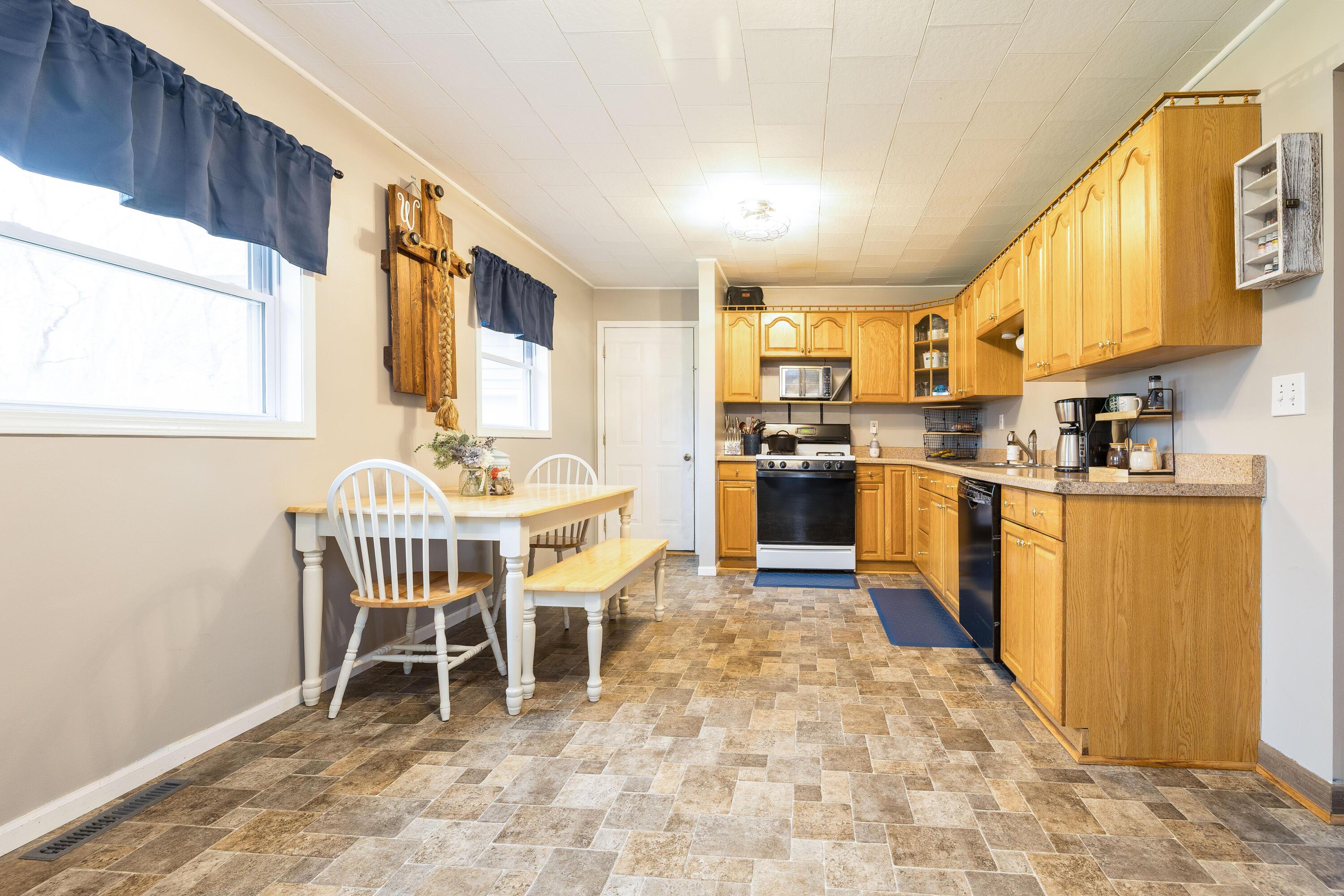 7612 Graefen Drive Demotte, IN 46310 - Photo 12 of 25 a kitchen with a sink a table and chairs