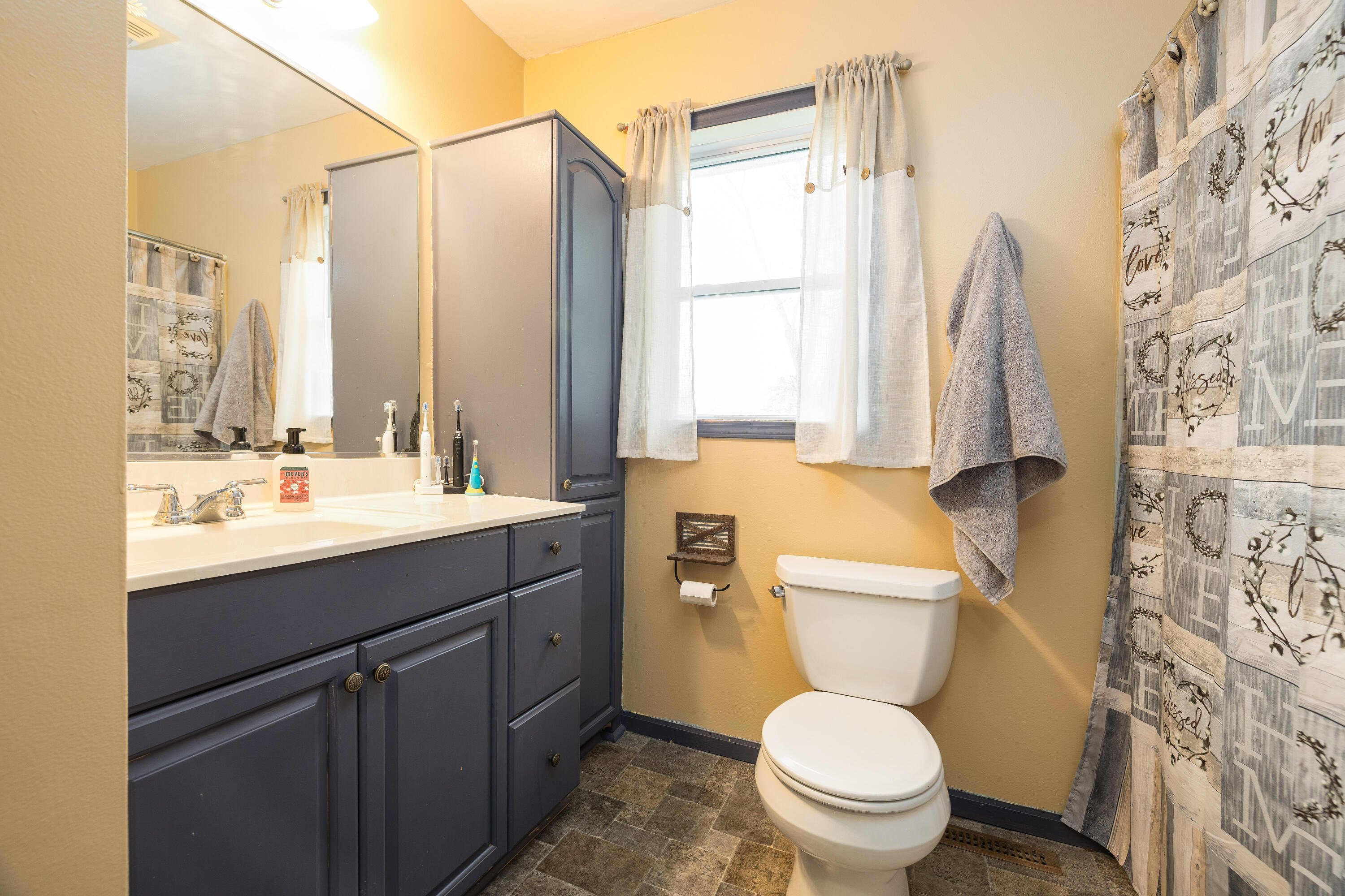 7612 Graefen Drive Demotte, IN 46310 - Photo 14 of 25 a bathroom with a sink a toilet and a mirror
