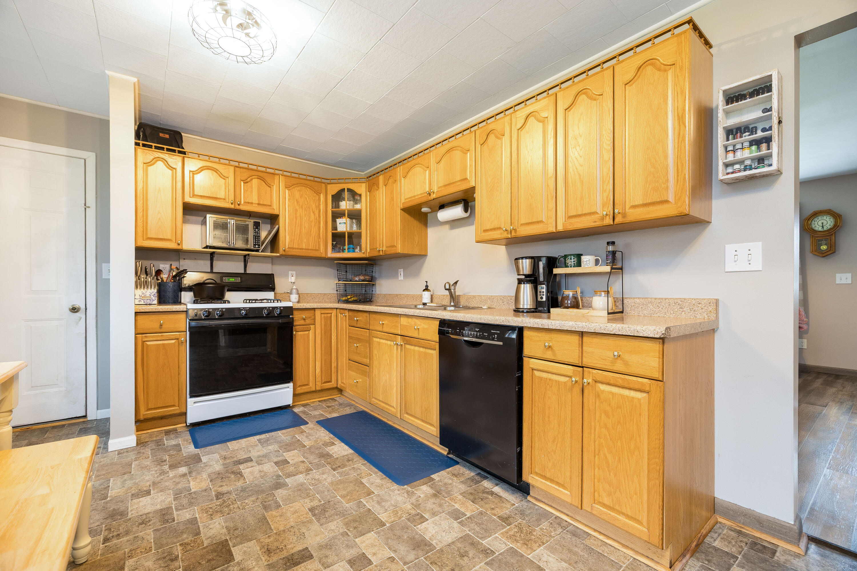 7612 Graefen Drive Demotte, IN 46310 - Photo 9 of 25 a kitchen with stainless steel appliances granite countertop a stove a sink and a refrigerator