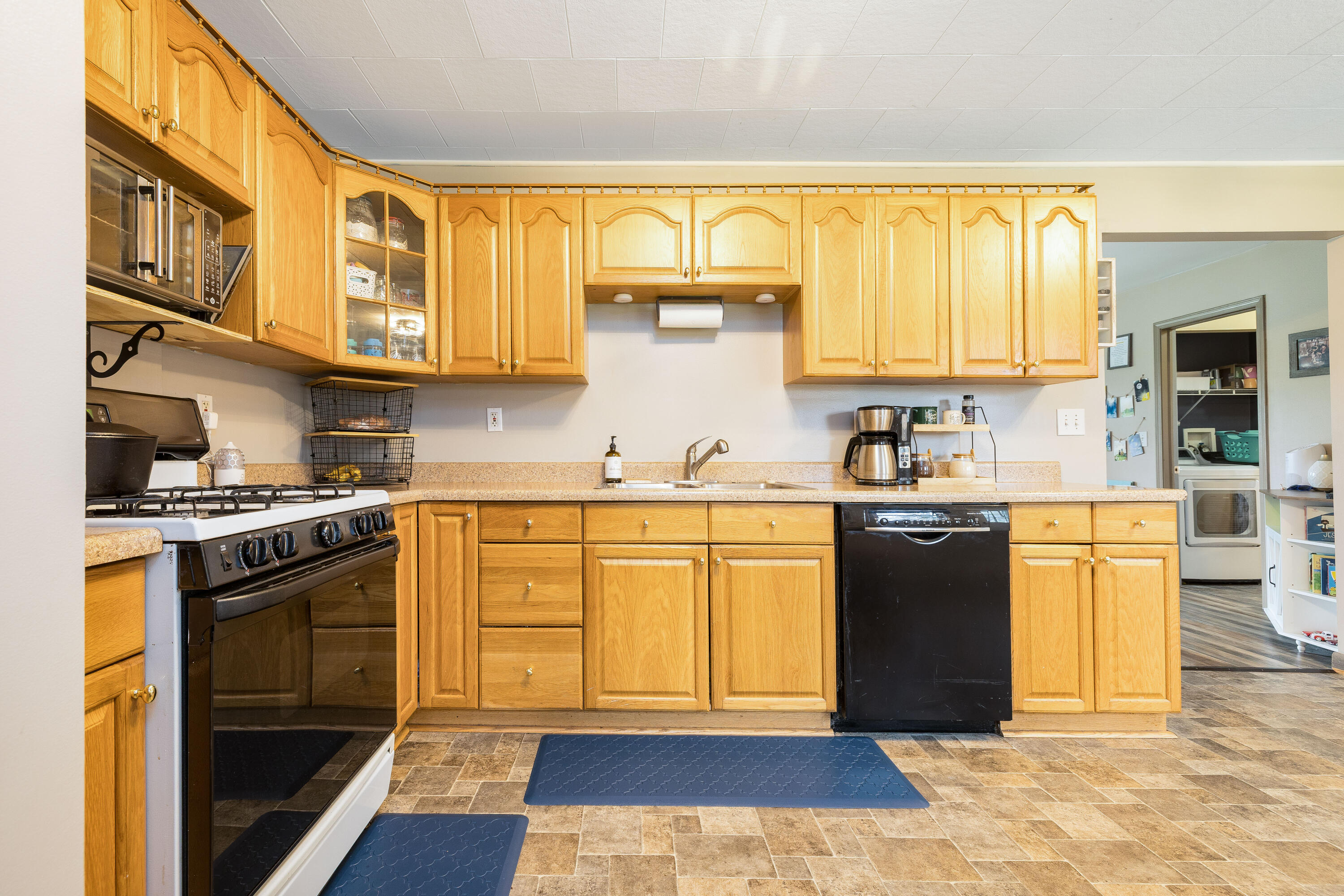 7612 Graefen Drive Demotte, IN 46310 - Photo 10 of 25 a kitchen with stainless steel appliances granite countertop a stove a sink and a refrigerator