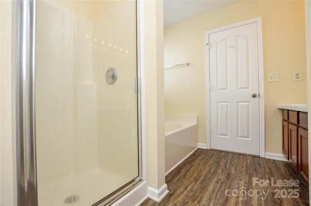 a view of a hallway with wooden floor and closet area