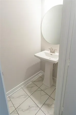a bathroom with a sink a toilet and mirror