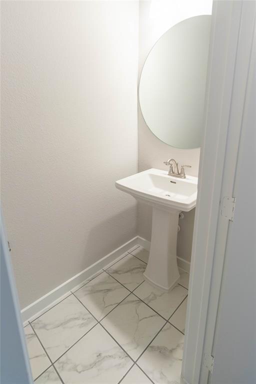 2348 Rook Drive Dallas, TX 75211 - Photo 11 of 21 a bathroom with a sink a toilet and mirror