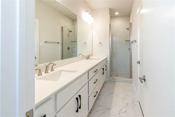 a bathroom with double vanity sink and a mirror