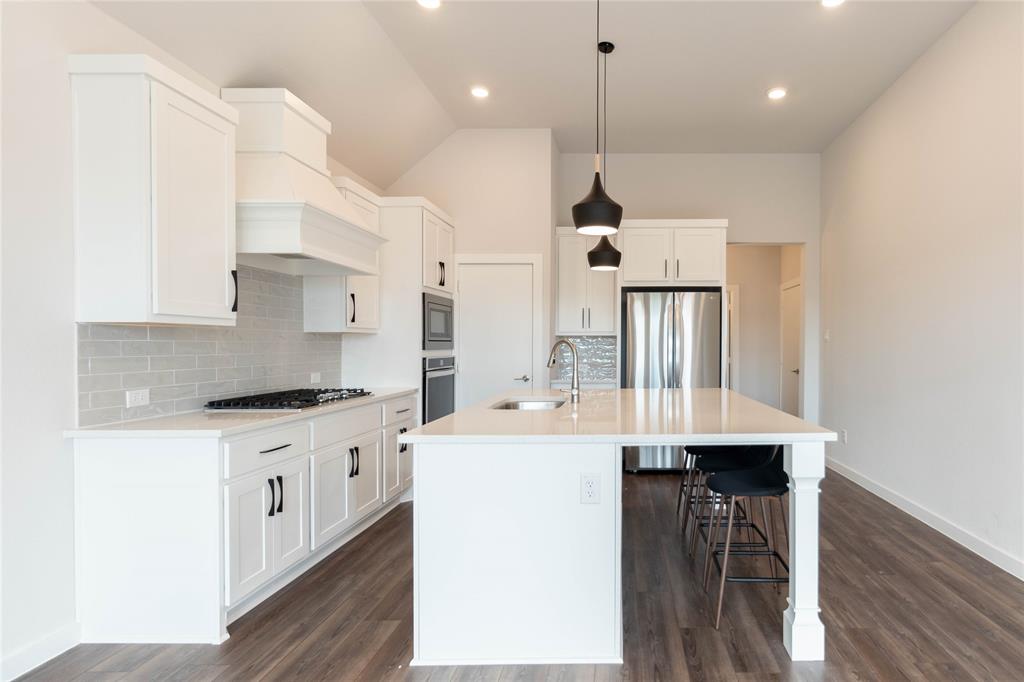 2348 Rook Drive Dallas, TX 75211 - Photo 3 of 21 a kitchen with stainless steel appliances kitchen island a large island in the center