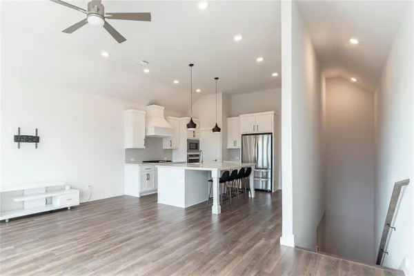 a large kitchen with a table and chairs