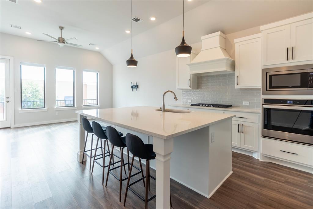2348 Rook Drive Dallas, TX 75211 - Photo 6 of 21 a kitchen with a table chairs sink and cabinets
