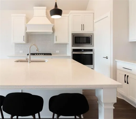 a kitchen with a sink a stove and refrigerator