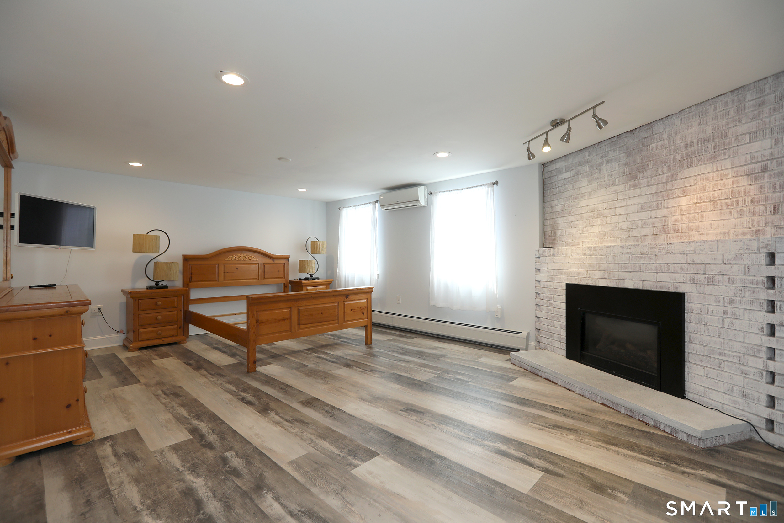 60 Ferguson Road Manchester, CT 06040 - Photo 12 of 18 Downstairs primary bedroom? Family Room? Home office? This room can be anything you would like it to be! It is beautiful AND functional...gas fireplace and spectacular spa bath included!