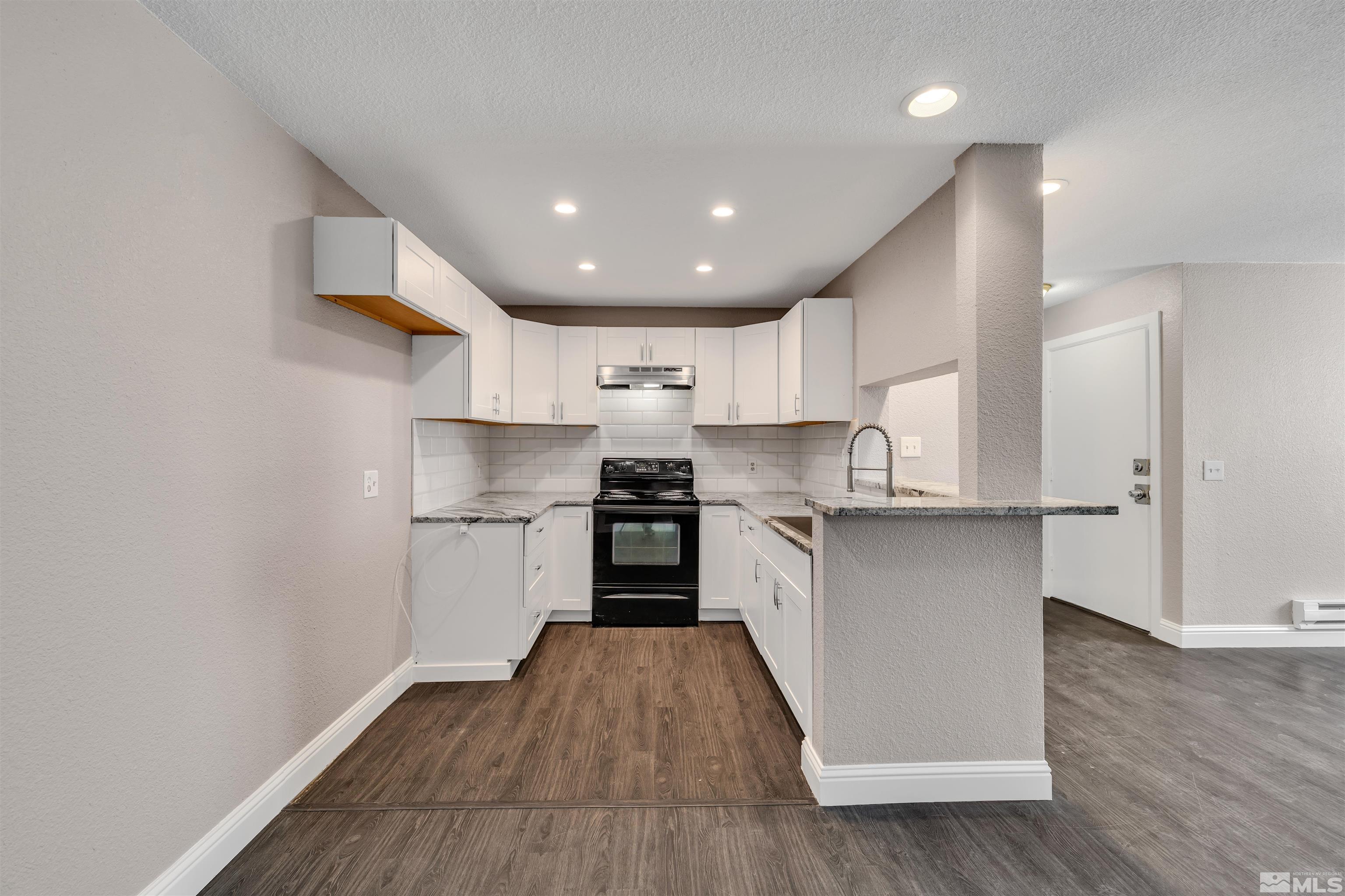 2095 Highview Court, Unit 3 Reno, NV 89512 - Photo 3 of 20 a kitchen with a refrigerator and a stove top oven