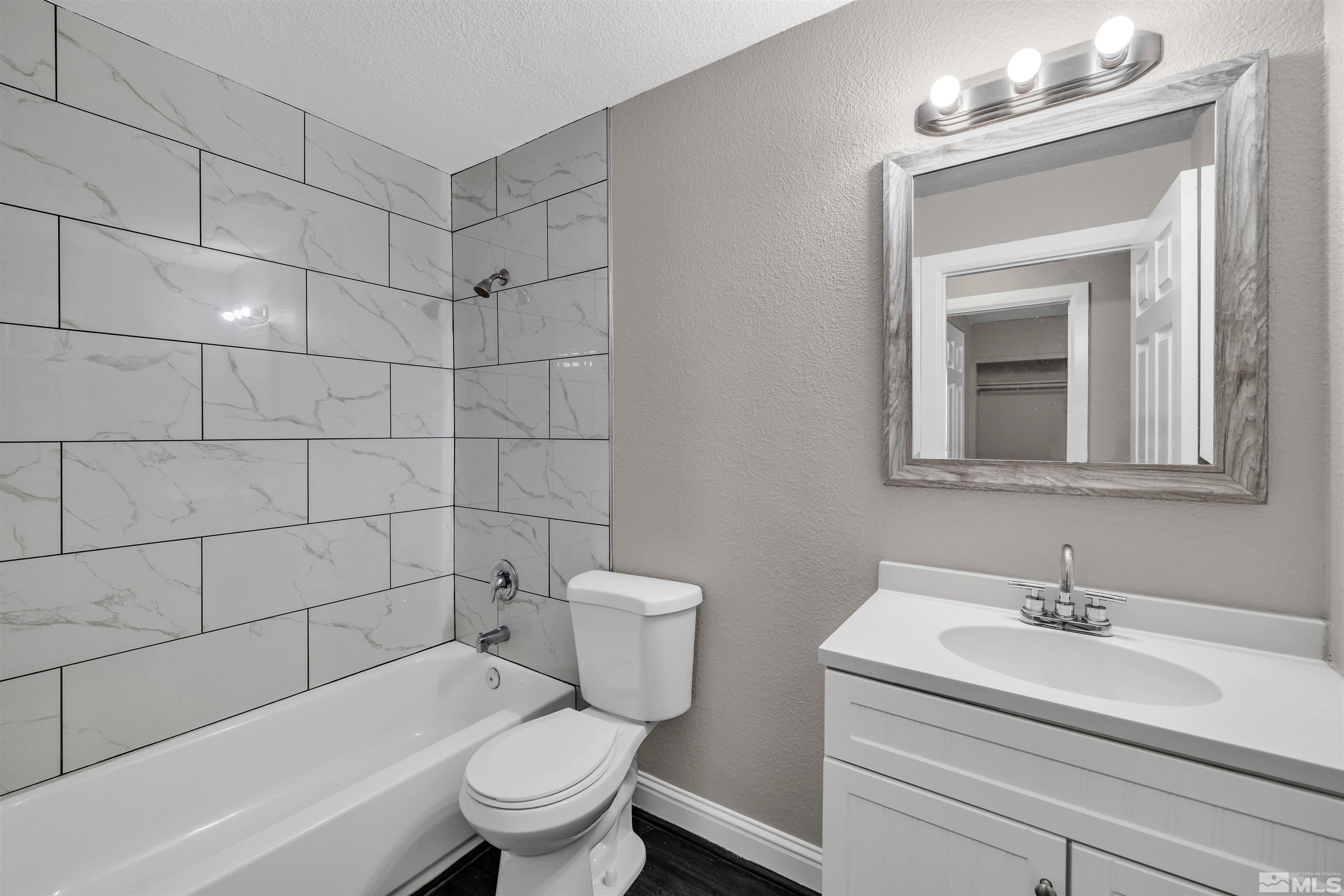 2095 Highview Court, Unit 3 Reno, NV 89512 - Photo 6 of 20 a bathroom with a sink toilet a mirror and shower
