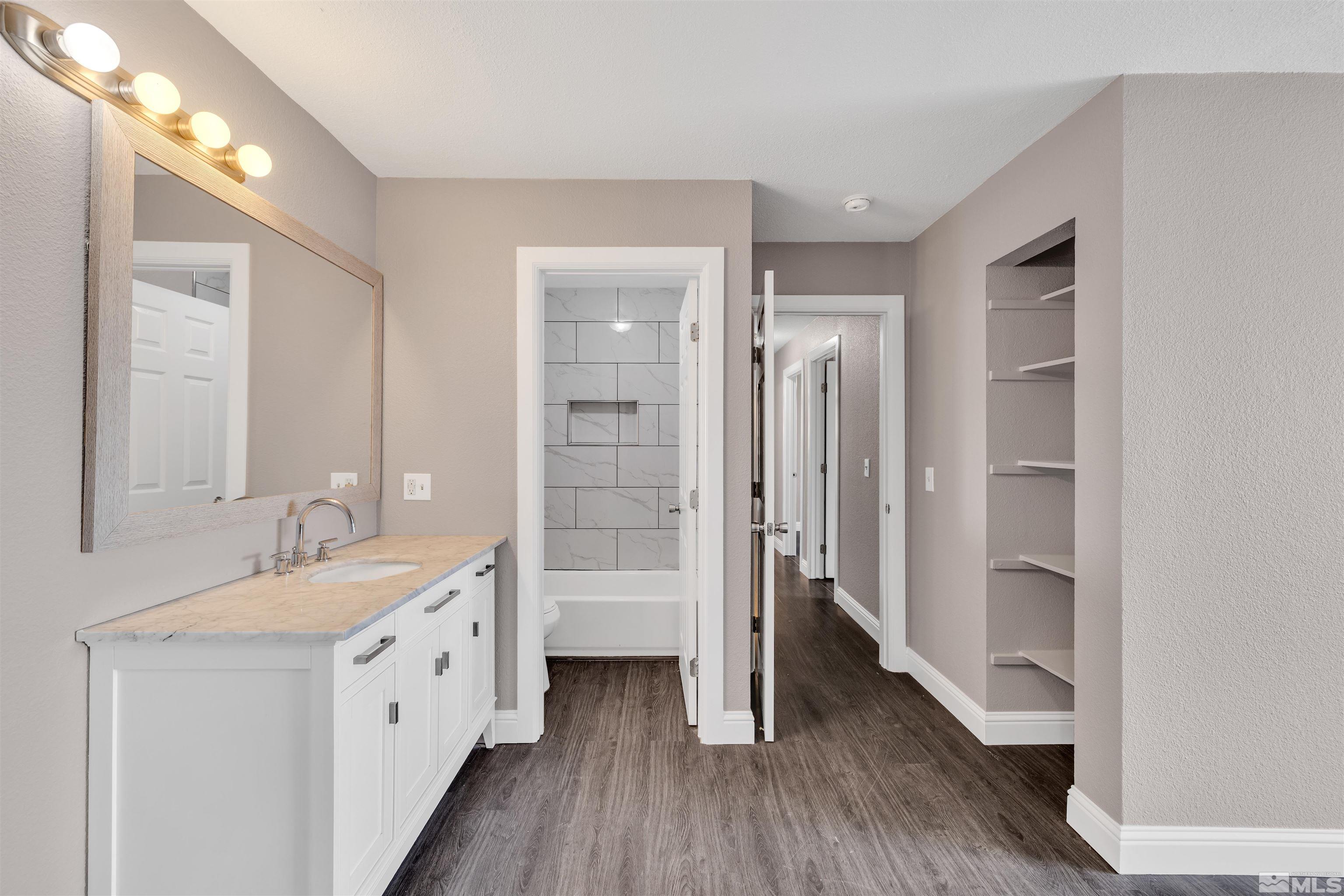 2095 Highview Court, Unit 3 Reno, NV 89512 - Photo 8 of 20 a bathroom with a double vanity sink a mirror and a shower
