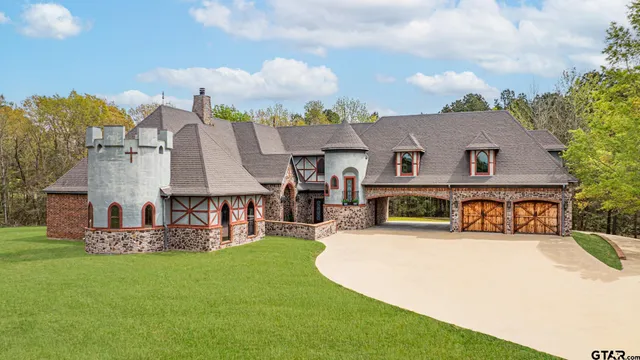 a view of a house with swimming pool and a yard