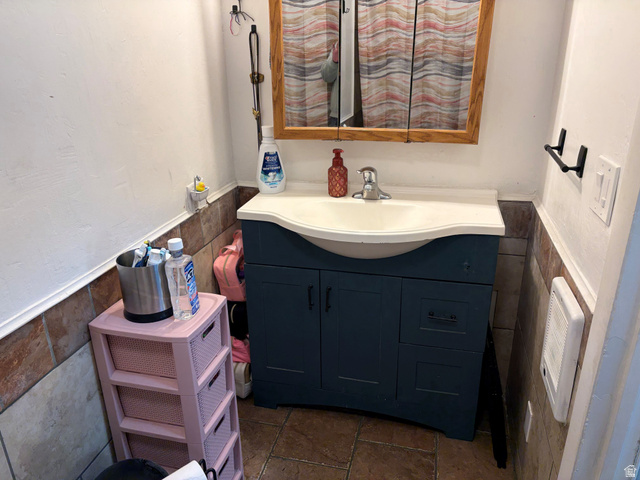 320 South State Street Preston, ID 83263 - Photo 8 of 20 Bathroom with wainscoting, tile walls, and vanity