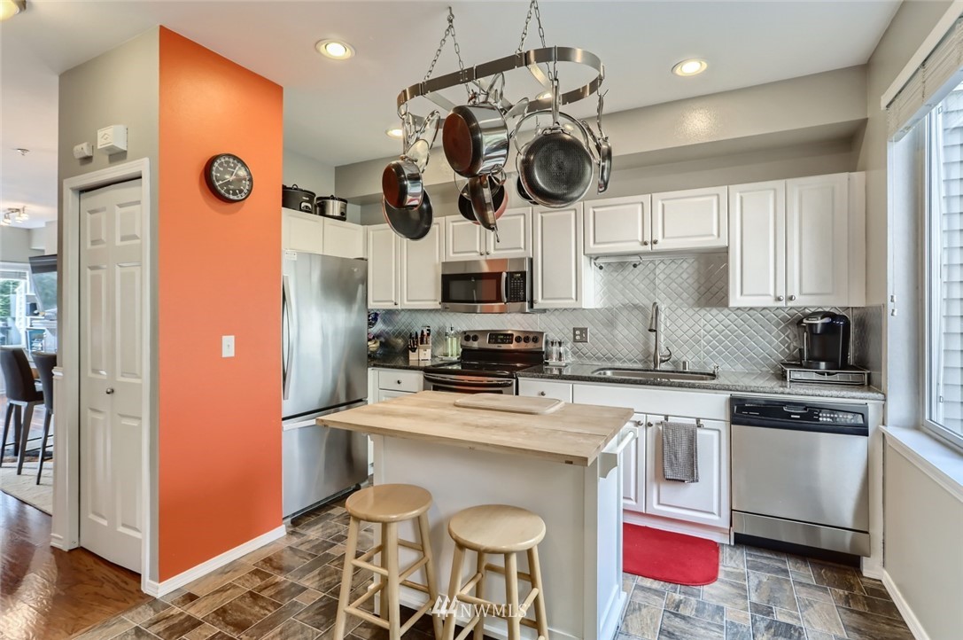 13400 Dumas Road, Unit E3 Mill Creek, WA 98012 - Photo 11 of 28 a kitchen with a refrigerator and a stove top oven