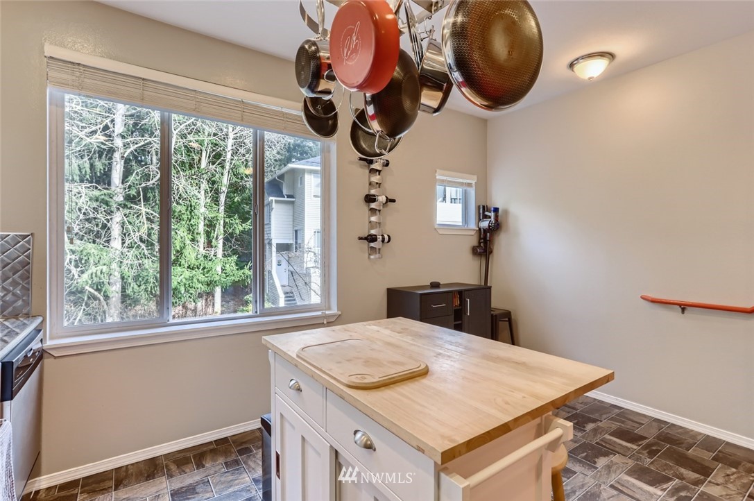 13400 Dumas Road, Unit E3 Mill Creek, WA 98012 - Photo 13 of 28 a kitchen with a sink a stove and a chandelier