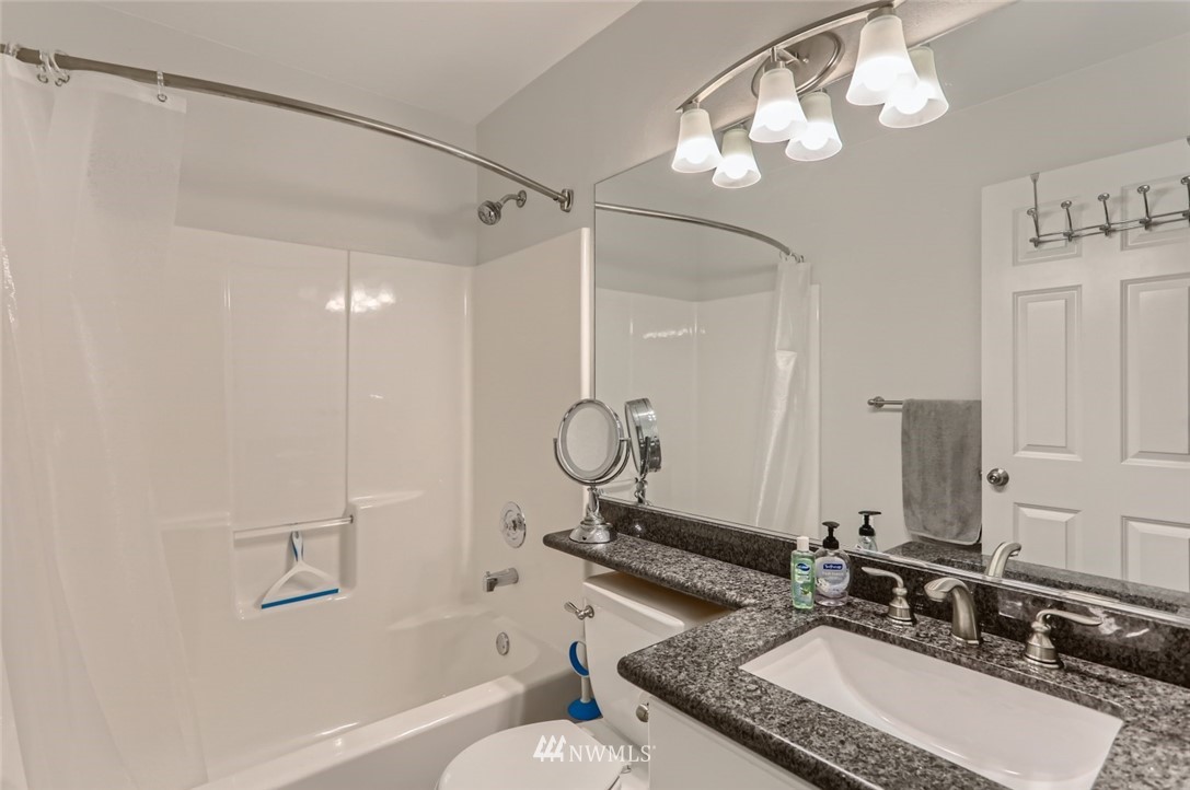 13400 Dumas Road, Unit E3 Mill Creek, WA 98012 - Photo 14 of 28 a bathroom with a granite countertop sink a toilet and shower