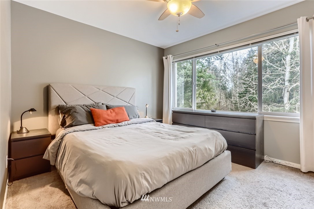 13400 Dumas Road, Unit E3 Mill Creek, WA 98012 - Photo 15 of 28 a bedroom with a bed and a large window