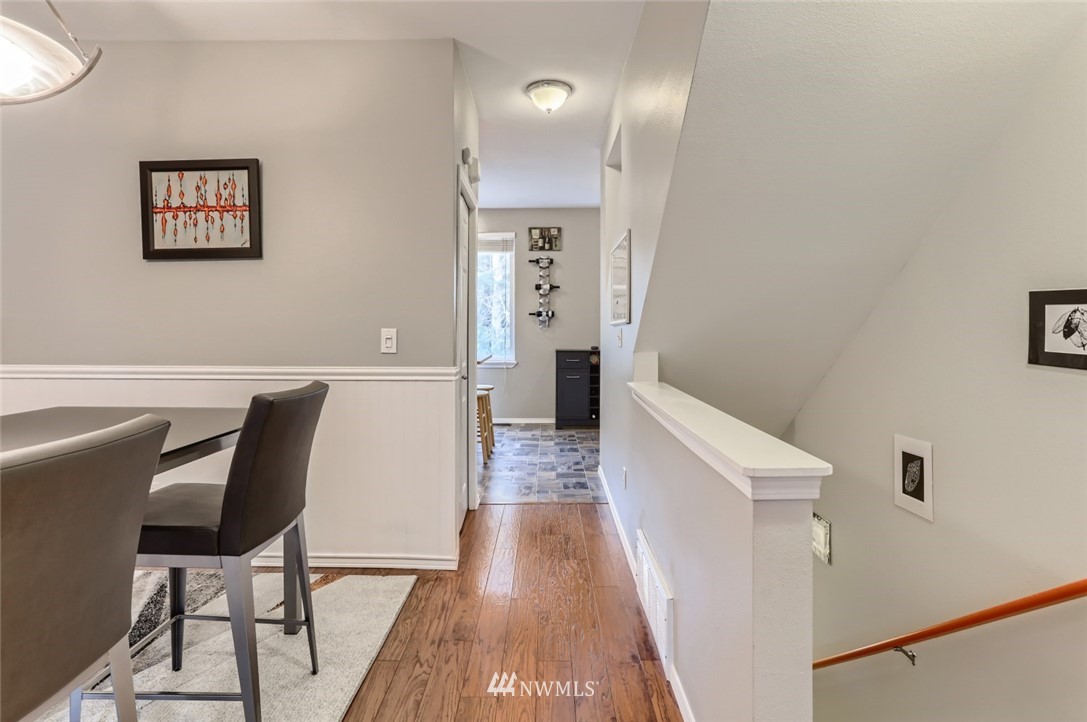 13400 Dumas Road, Unit E3 Mill Creek, WA 98012 - Photo 24 of 28 a view of a hallway to a livingroom with furniture and wooden floor