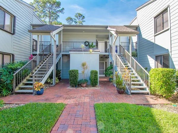 a view of a chair and table in the house front of house