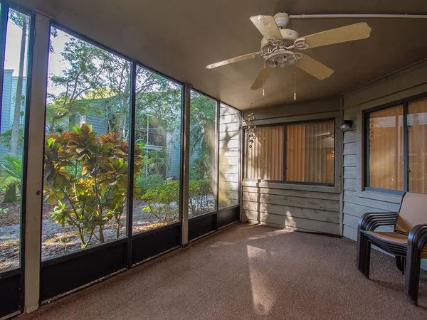 a very nice looking room with a large window and furniture