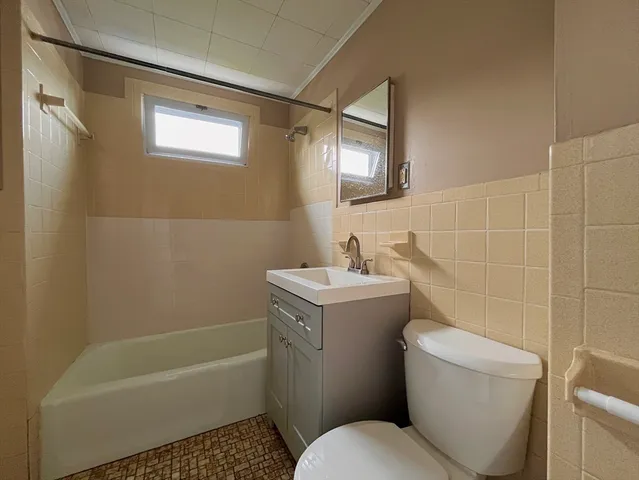 a bathroom with a sink a toilet and bathtub