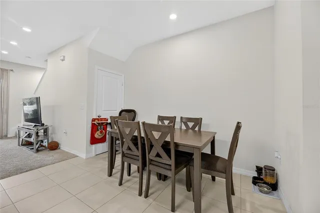a living room with furniture kitchen view and a chandelier
