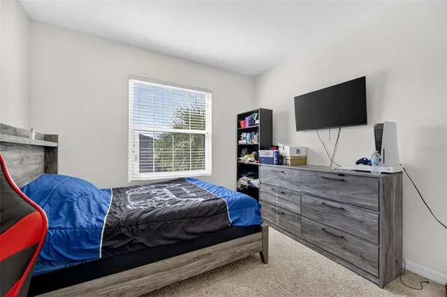 a front view of a house with yard and trees