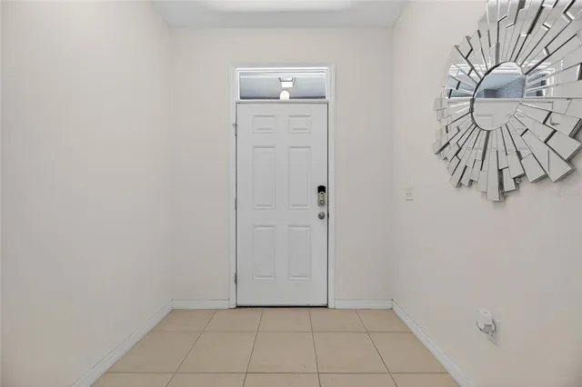 a kitchen with stainless steel appliances a stove a sink a oven a dining table and chairs