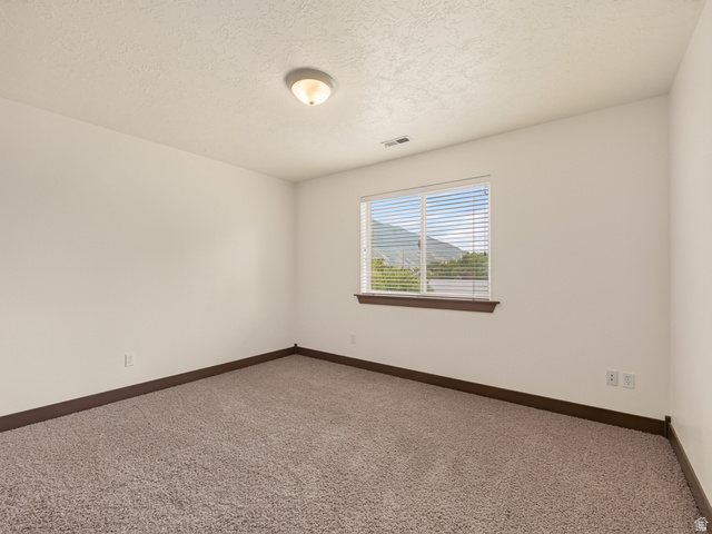 1279 West 1500th Street North Mapleton, UT 84664 - Photo 37 of 83 Neutral tone wall finish with a single window featuring horizontal blinds